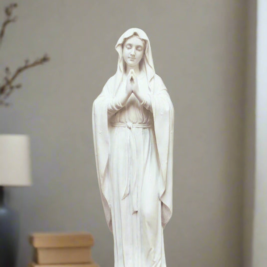 Adorning Virgin Mary Statue in white finish. Mary has her hands together in prayer. 